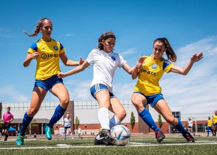 BURLINGTON, ON – JUN. 19, 2022: Players from Darby FC and Burlington SC battle for the ball during League1 Ontario regular season action.