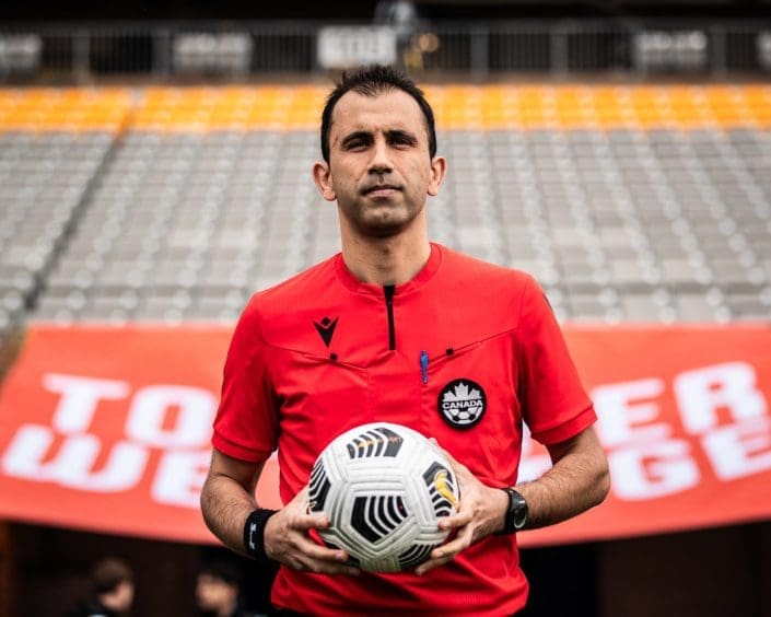 HAMILTON, ON – APR. 22, 2023: Referee Roain Satarzadeh of League1 Ontario enters the pitch at Tim Hortons Field.